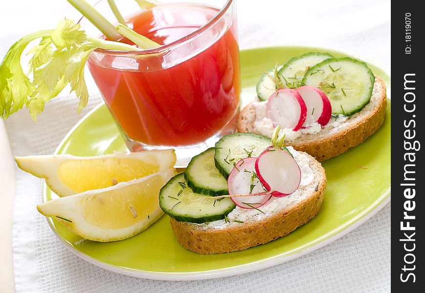 Healthy sandwiches with radish and cucumber on plate with tomato juice. Healthy sandwiches with radish and cucumber on plate with tomato juice