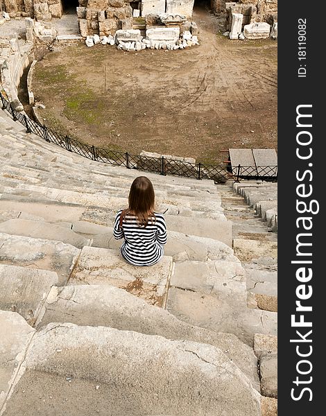 Girl with a striped dress sitting in the amphitheater. Girl with a striped dress sitting in the amphitheater