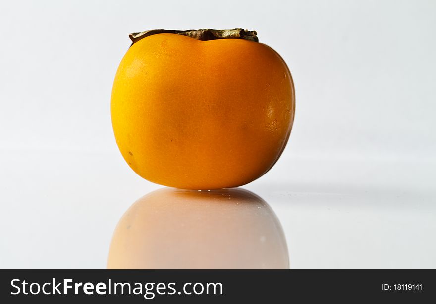 Ripe persimmon isolated on Glass