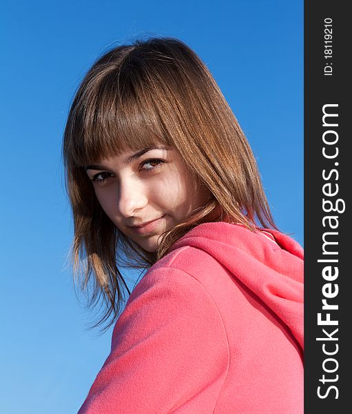 Portrait of a beautiful young woman against the sky