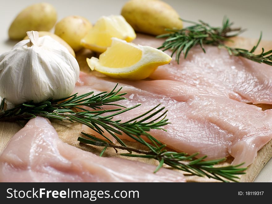 Fresh chicken with rosemary, potatoes, garlic and lemon