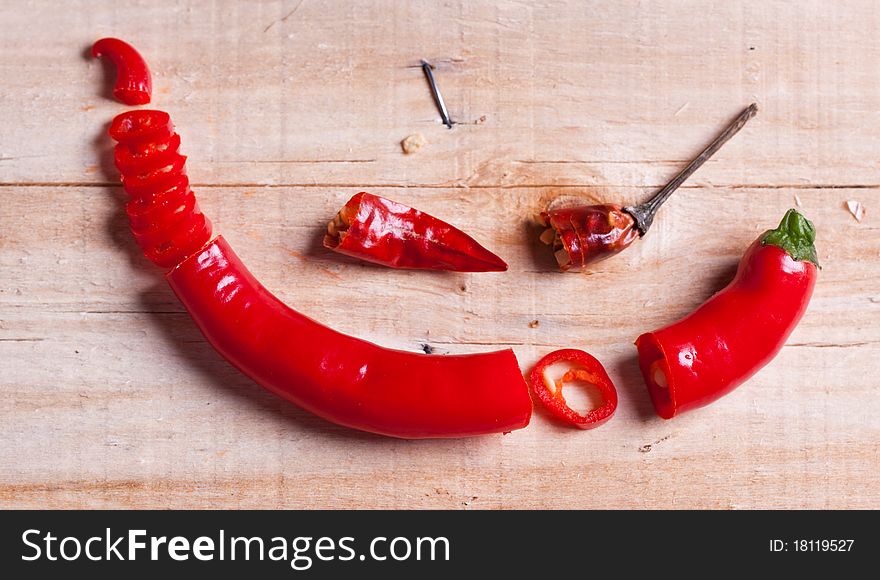 Sliced red hot chili pepper and little dry pepper on wooden desk. Sliced red hot chili pepper and little dry pepper on wooden desk