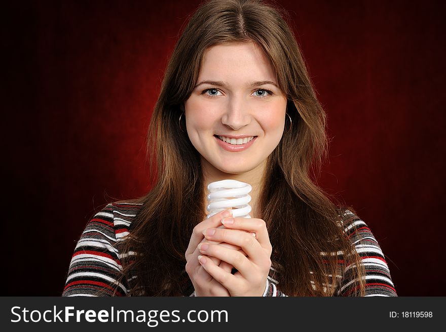 Woman holding an fluorescent light bulb