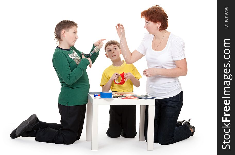 Mother with children involved in scrapbooking table