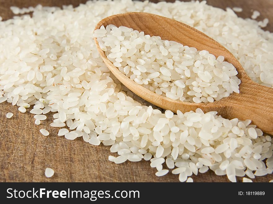 Rice grain in wooden spoon. Rice grain in wooden spoon