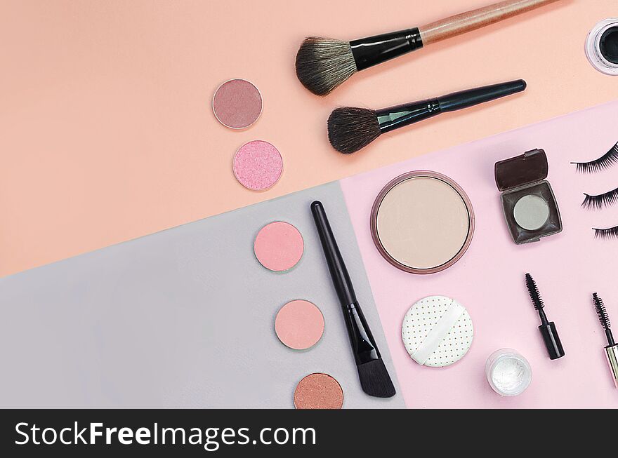 Colorful cosmetics lying on pastel background. Makeup set. Flatlay background for design. Colorful cosmetics lying on pastel background. Makeup set. Flatlay background for design