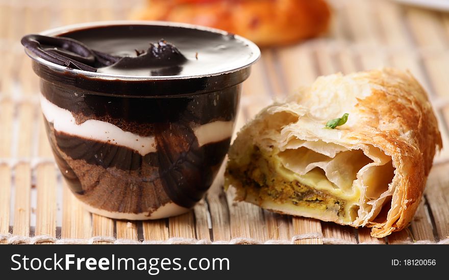 Chocolate pudding with danish pastry over wooden background. Chocolate pudding with danish pastry over wooden background.