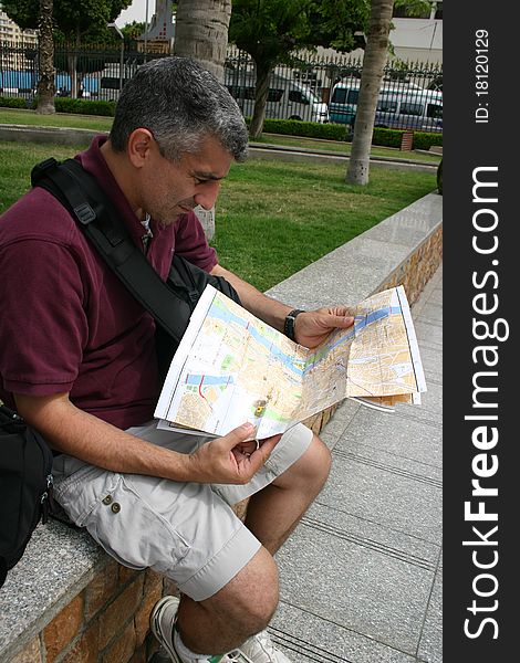 A tourist in Cairo Egypt is looking at a map. A tourist in Cairo Egypt is looking at a map.