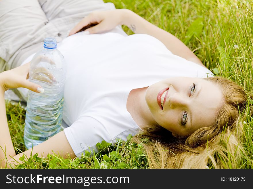 Lying woman with bottle of water