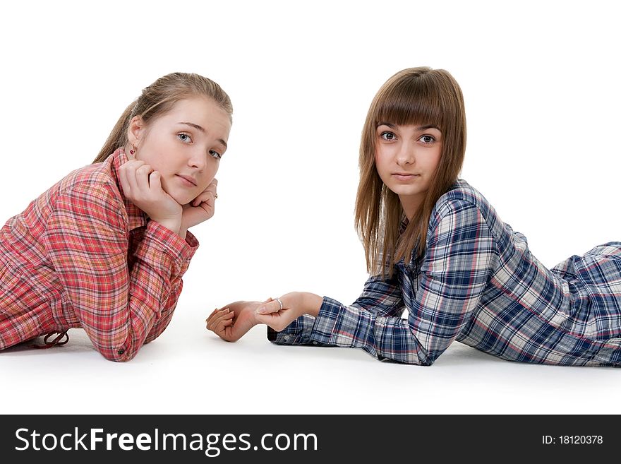 Two young beautiful girls lying on the floor