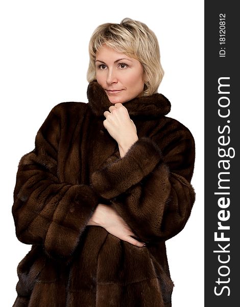 Portrait of a beautiful girl in a mink coat on a white background