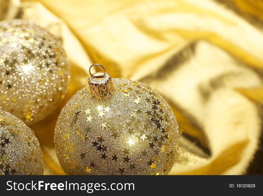 Gold Christmas balls in golden background