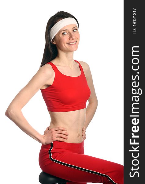 Happy young woman in red sport clothes exercising; isolated on white. Happy young woman in red sport clothes exercising; isolated on white