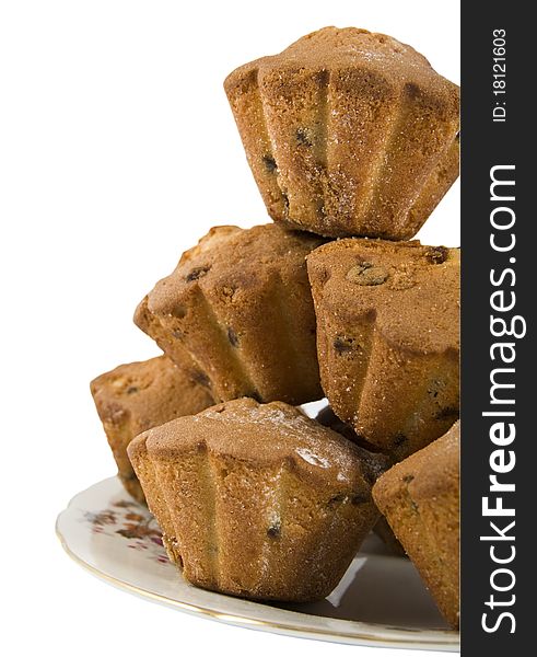 Cakes with a raisins are laid out by a hill on a dish