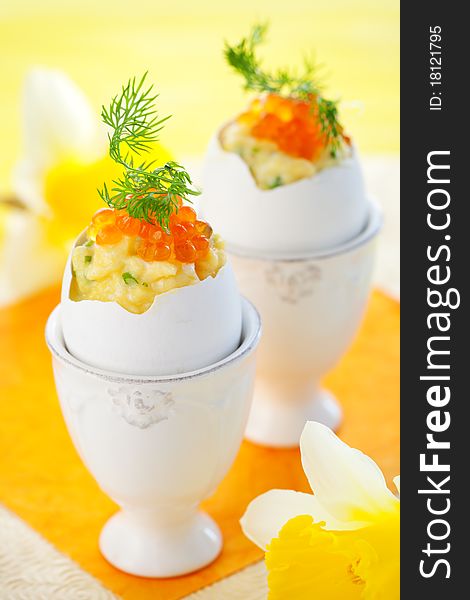 Eggs stuffed with scrambled egg with chives and red caviar