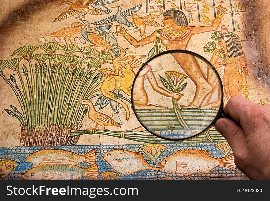 Hand with big magnifying glass on old antique egyptian papyrus discovering. Hand with big magnifying glass on old antique egyptian papyrus discovering