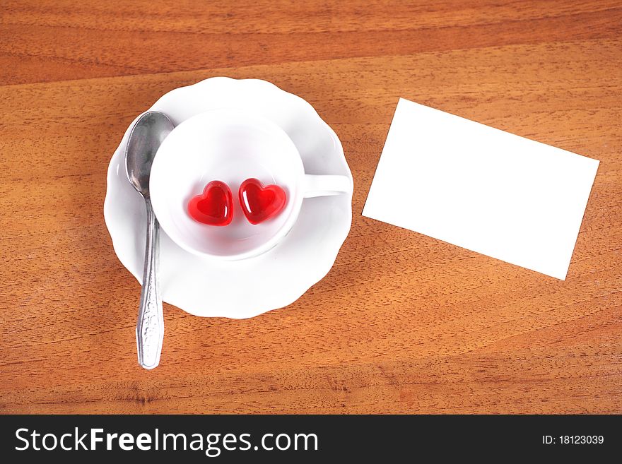 Coffee cup and heart on a brown background