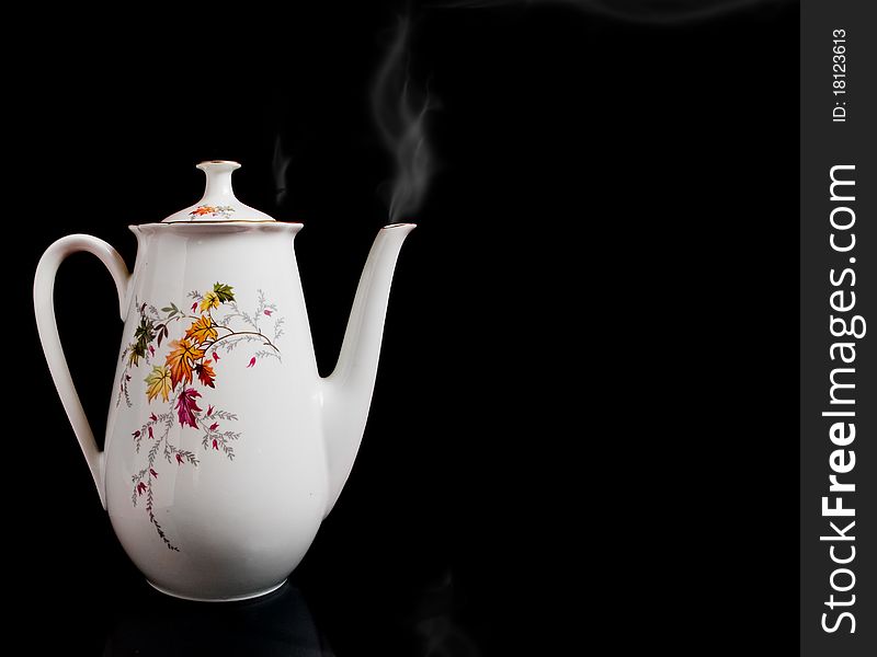 Big white kettle with pair or smoke isolated on black - lit a soft. Big white kettle with pair or smoke isolated on black - lit a soft