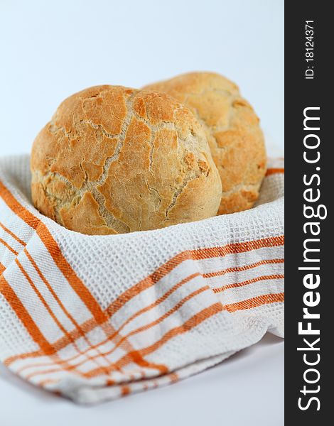 Home made bread in a light background on a basket with orange square texture