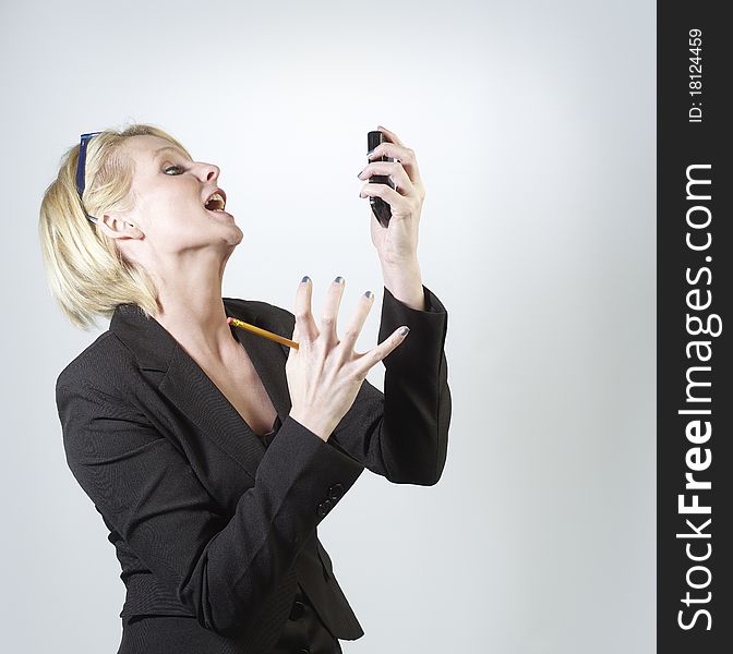 Businesswoman shouting into mobile phone. Businesswoman shouting into mobile phone