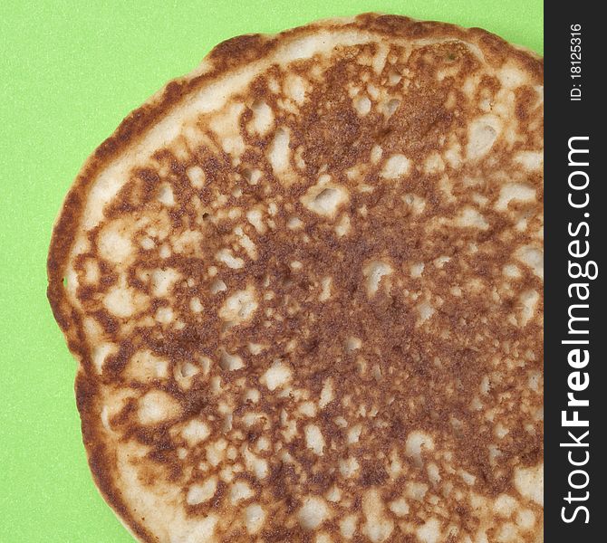 Modern Close Up of Pancake on a Vibrant Green Background.