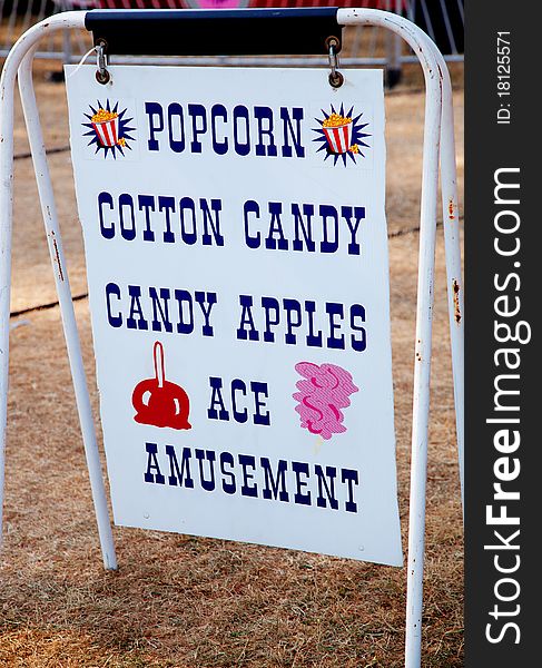 Photo of a Popcorn and other sweets sign at a carnival. Photo of a Popcorn and other sweets sign at a carnival.