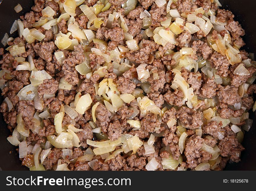 Minced meat and onion being fried on a pan