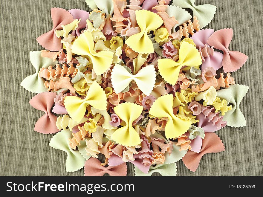 Colorful vegetable pasta on a textured background, top view. Colorful vegetable pasta on a textured background, top view