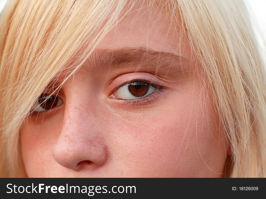 Close up of the blonde girl with brown eyes.