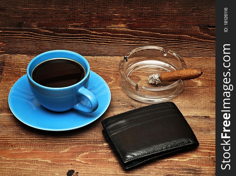 Coffee, cigars and purse on wood background