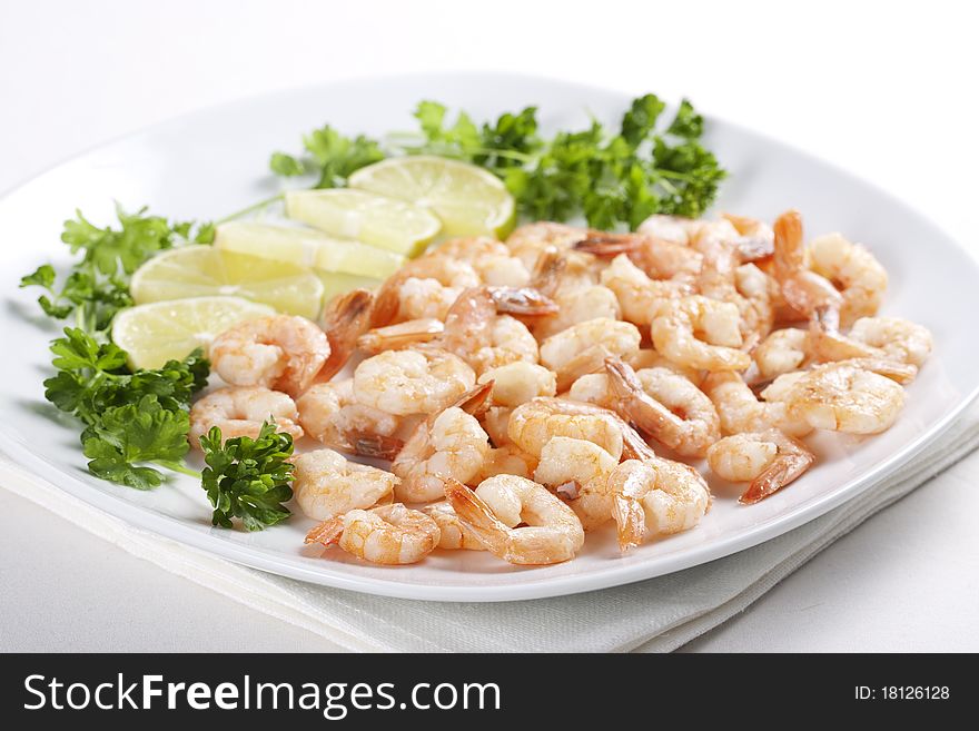 Shrimps on a plate with lime and parsley. Shrimps on a plate with lime and parsley