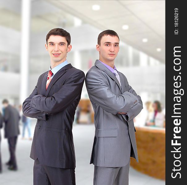 Two young businessman posing back together team portrait