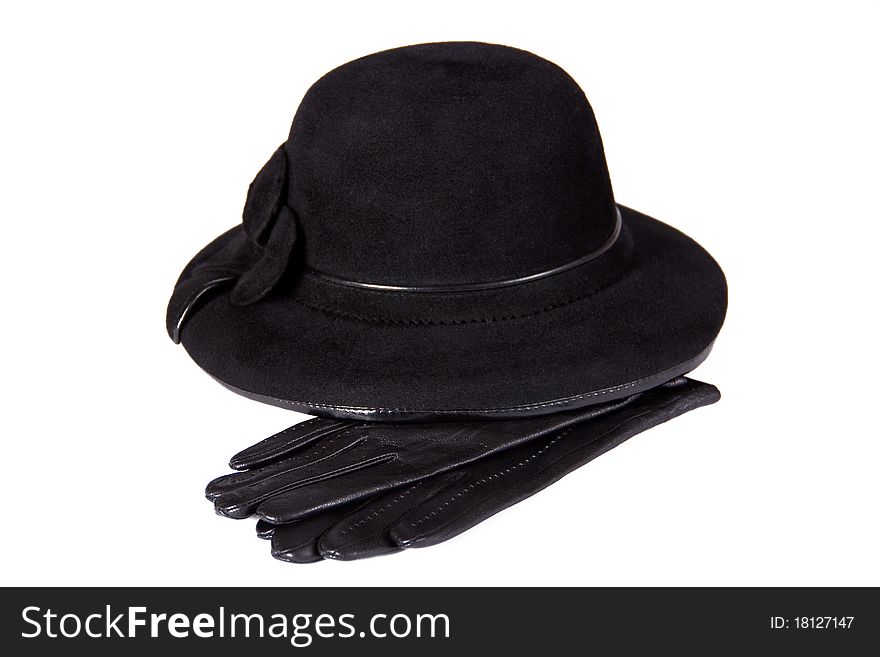 Images of a female hat lying on the leather gloves, isolated, on a white background. Images of a female hat lying on the leather gloves, isolated, on a white background