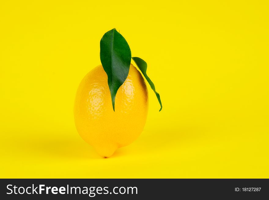 Fresh lemon on the yellow background.