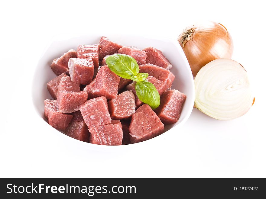 Diced beef with onion over white background. Diced beef with onion over white background