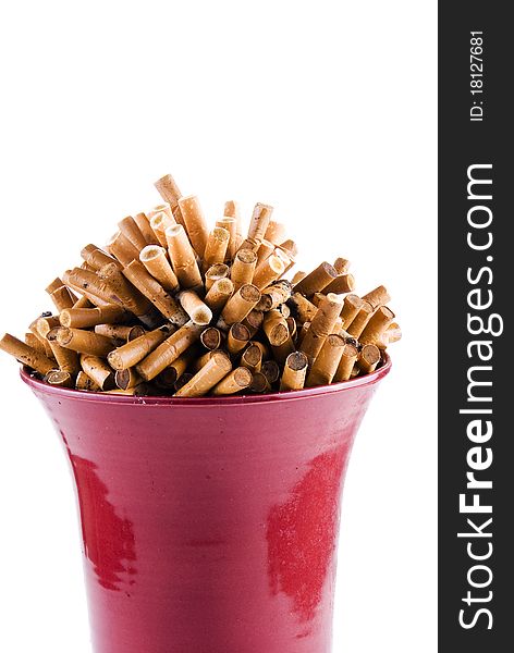 Full bowl of cigarettes end over white background