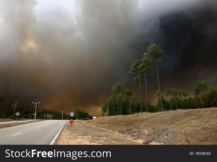 Very thick smoke from a forest fire fills the air and sky. Very thick smoke from a forest fire fills the air and sky