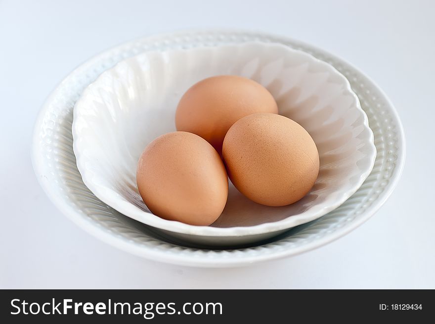 A white bowl full of organic eggs