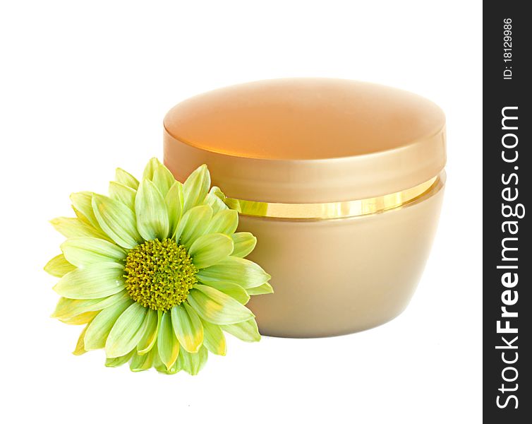 Container of cream and fresh green daisy flower isolated.