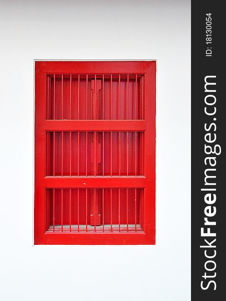 Red thai style window on white wall