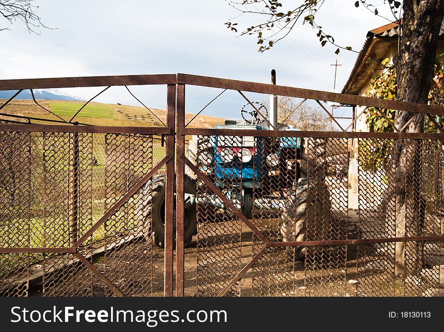 Blue tractor in the home yard in Carpathian village, Ukraine. Blue tractor in the home yard in Carpathian village, Ukraine