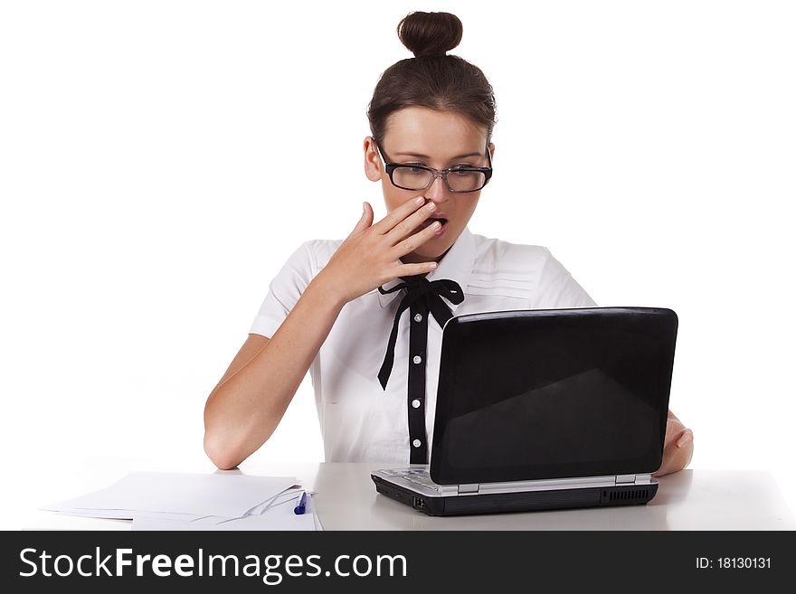 Woman with glasses sits and working on laptop