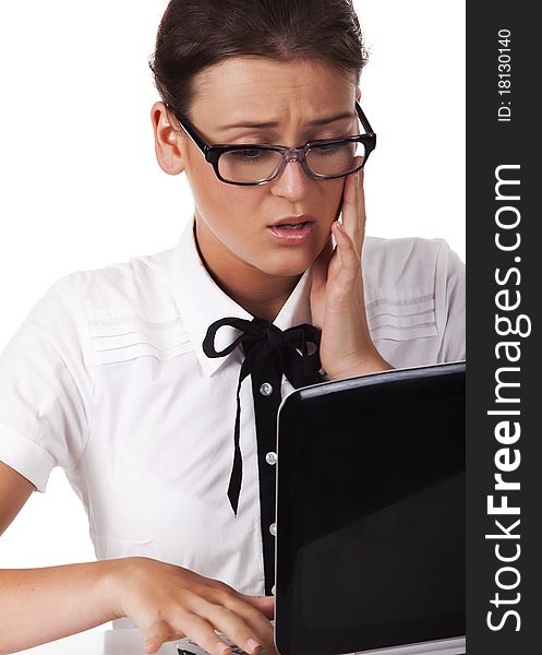 Woman with glasses sits and working on laptop