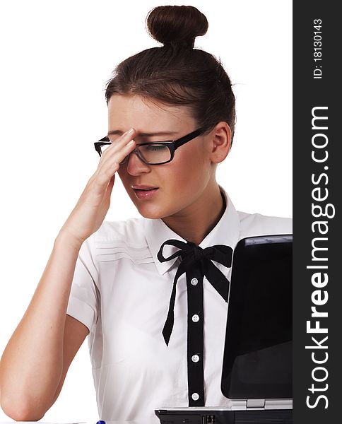 Woman with glasses sits and working on laptop