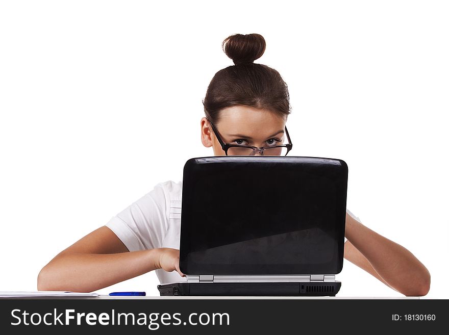 Woman with glasses sits at a table looks out from for the laptop and working on laptop A series of office work. Woman with glasses sits at a table looks out from for the laptop and working on laptop A series of office work