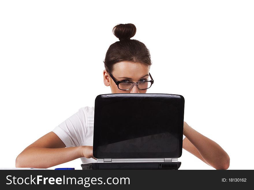 Woman with glasses sits at a table looks out from for the laptop and working on laptop A series of office work. Woman with glasses sits at a table looks out from for the laptop and working on laptop A series of office work