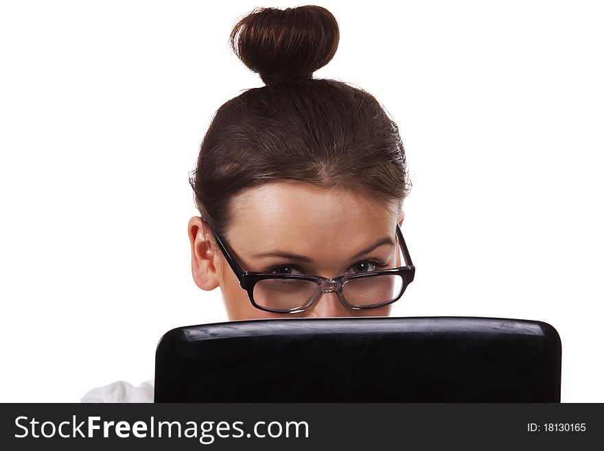 Woman with glasses sits at a table looks out from for the laptop and working on laptop A series of office work. Woman with glasses sits at a table looks out from for the laptop and working on laptop A series of office work