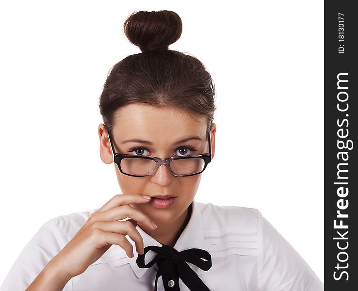 Girl with glasses holds a hand near the mouth on a white background