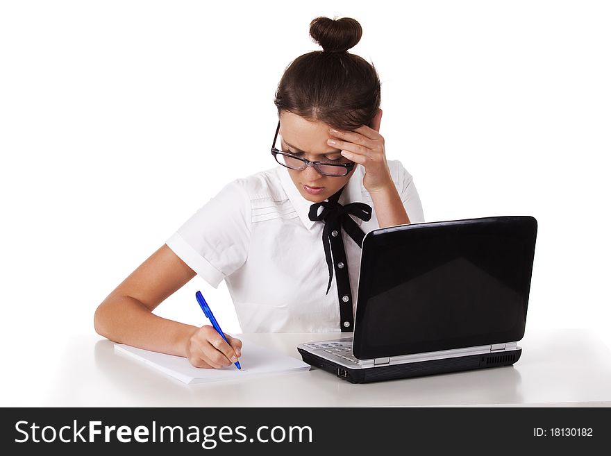 Woman with glasses sits and working on laptop