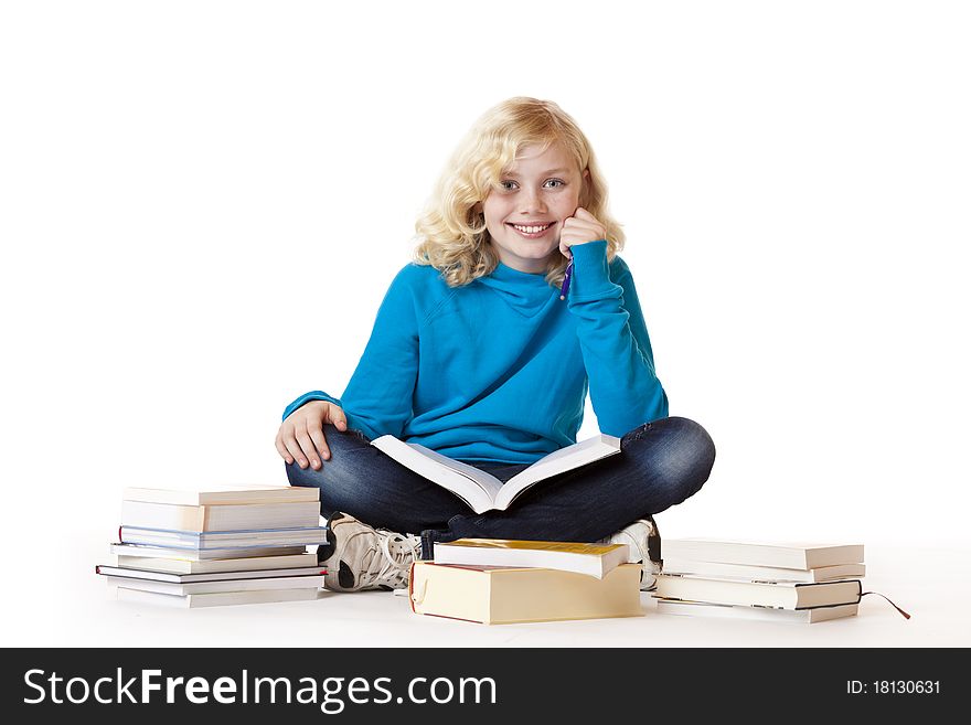 Schoolgirl Sitting On Floor Learning With Books